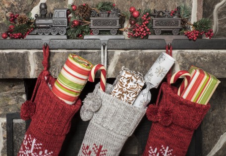 Stuffed stockings hanging on a fireplace on christmas morning